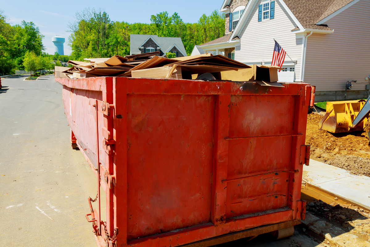 Loaded Dumpster near a Construction